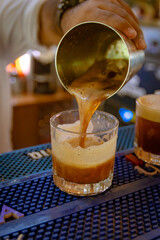 Bartender pouring alcoholic carajillo
