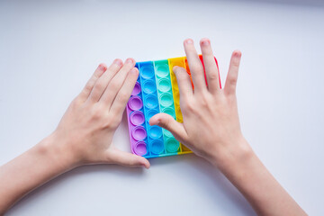 Antistress pop it toy. Rainbow sensory fidget isolated on white background. New trendy silicone toy.