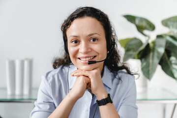 Successful caucasian mature businesswoman hot line worker IT support working remotely in headset at...