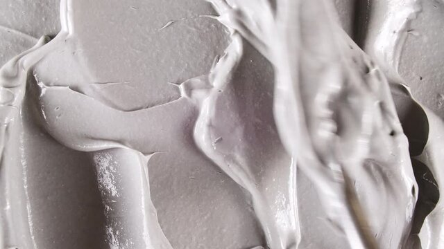 Motion of the Liquid cream, white cosmetic texture with rotation. Contouring, Make up smears background. Organic cosmetics, medicine. Top view. 4K UHD video. High quality 4k footage