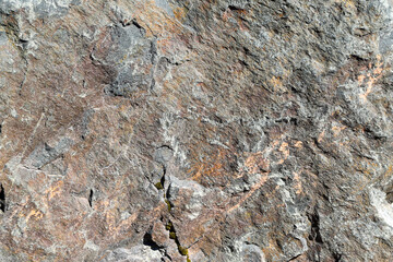 Texture of a colorful natural stone with green moss