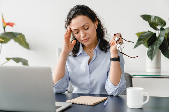 Depressed Caucasian Mature Middle-aged Businesswoman Feeling Headache On Workplace, Suffering From Migraine Or Menopause. Sick Leave, Illness And Fatigue At Office.