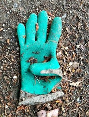 Environmental problem, a dirty used rubber glove was left on the ground.