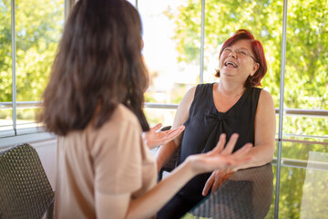 Mother and daughter at home having a talk at home