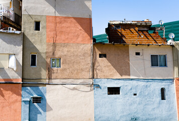 Fototapeta na wymiar External walls of precarious apartment buildings painted with different colors in Buenos Aires, Argentina.