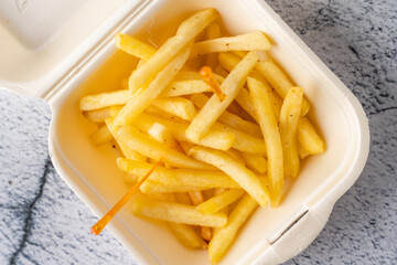 French fries potato chips in portion for delivery pick up lunch close up top view