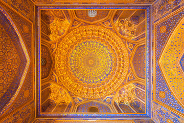 Fototapeta na wymiar Interior of Tilya Kori Madrasah and Mosque in Registan Square in Samarkand, Uzbekistan. Geometrical decoration of gold applied by the method of kyndal