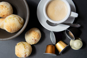 CHEESE BREAD OVER A TABLE WITH A CUP OF ESPRESSO COFFEE BESIDE DE BOWL