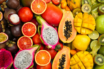 Many different delicious exotic fruits as background, top view