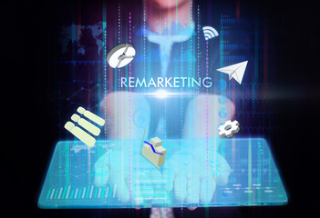 Business, Technology, Internet and network concept. Young businessman working on a virtual screen of the future and sees the inscription: Remarketing