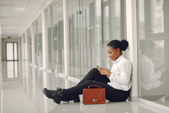 Black Woman Standing In The Office With A Laptop