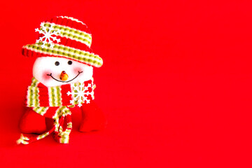 Christmas decoration. Rag doll on red background. Snowman.