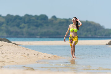 Fototapeta premium Portrait of thai woman posing outdoors at the sea beach