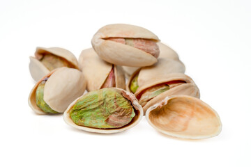 Pile of pistachios in the peel on white background.