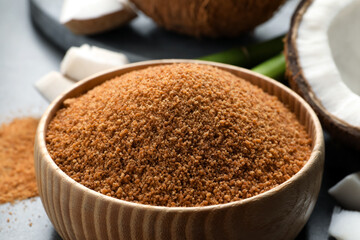 Natural coconut sugar in wooden bowl, closeup