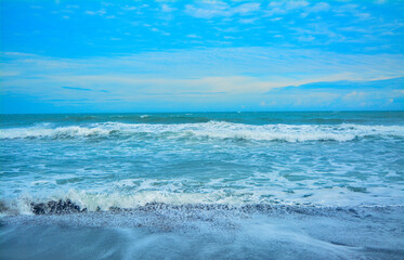 Waves on the beautiful Indonesian sea coast. Ocean waves crashing on a sunny day in nature