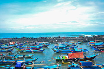 Fototapeta na wymiar Harbor view filled with fishing boats in Indonesia. Beautiful traditional fishing boats. Traditional people 