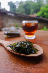 Photo of chopped seaweed and a cup of coffee and mangosteen beside it, a photo of the meaning of the drink