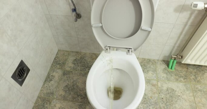 Peeingall over a toilet