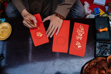 Vietnamese artist writes Tet calligraphy, Happy New Year in Vietnamese means (" Chuc mung nam moi ") at Youth Cultural House, Ho Chi Minh city, Vietnam