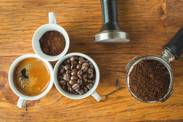 Coffee cup and beans on old kitchen table