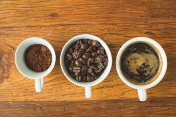 Coffee cup and beans on old kitchen table