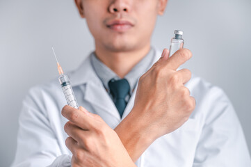 Doctor or scientist carries a syringe and a vaccine against COVID-19, vaccination and laboratory...
