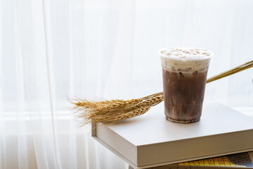 ice cocoa chocolate milk drink in glass on wooden table. drink food menu. copy space for text.