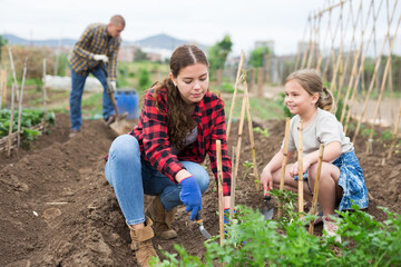Mother and daughter working in the garden
