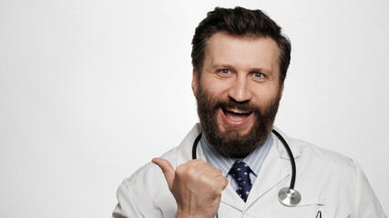 Doctor YES emotion gesture. Excited joyful man doctor on white background looking at camera and emotionally clenches his hand into fist and shows his satisfaction and possibly victory