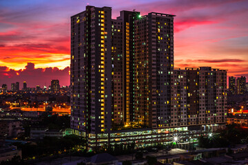 Highly blurred background from the residence,with a panoramic view of the city(condominium,office,home offices,houses,football fields,bridges across the river) and colorful colors from the evening sky