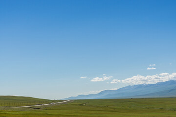 Mountains and grasslands along G217 highway in Xinjiang, China in summer