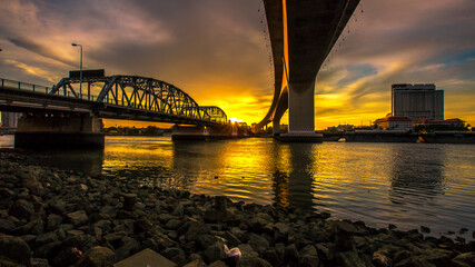 Blurred abstract background of evening sky light under the bridge over the river, the beauty of...