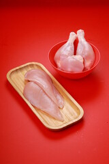 Raw whole chicken leg  and breast fillet_grey board