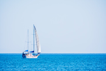 Fototapeta premium Sailing yacht in the blue calm sea.
