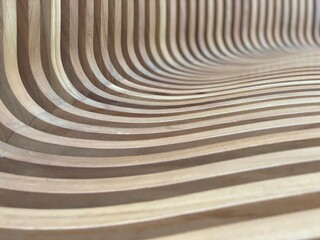 close up on the curves of this wood carved bench creating a wave of images