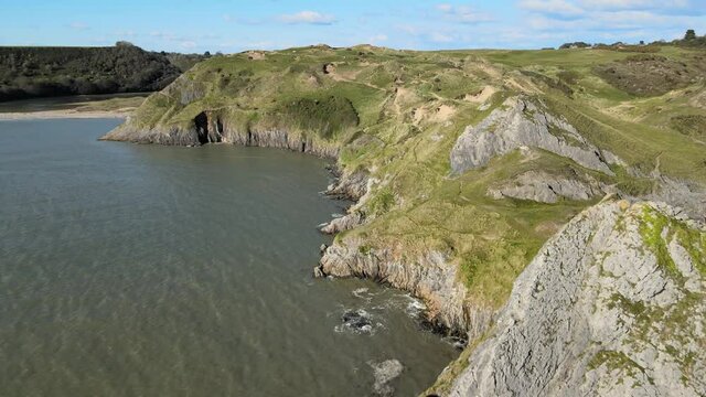 Limestone Sea Cliffs At Summer Near Three Cliffs Bay Beach In Swansea, Wales, United Kingdom. - aerial