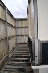 Cooling tower enclosure with metal walkway