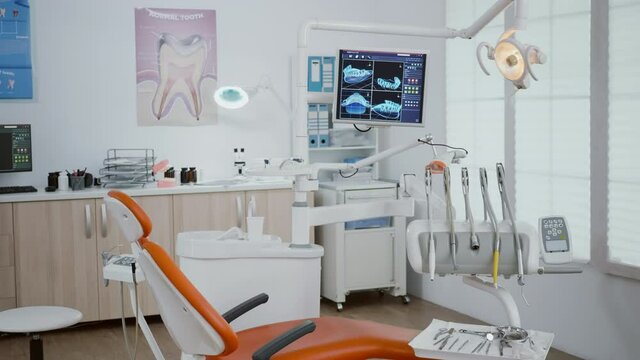 Closeup of revealing shot of stomatology orthodontist office equipped with dental drill and dentistry chiar ready for dental health treatment. Zoom in shoot of professional teeth instruments