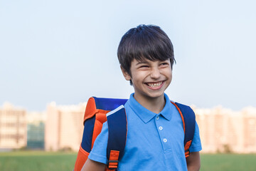Returning to school concept, portrait of happy boy with backpack, school child waiting for school...