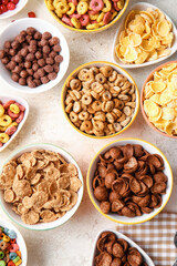 Bowls with different cereals on light background