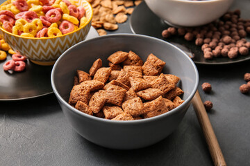 Different cereals on dark background, closeup