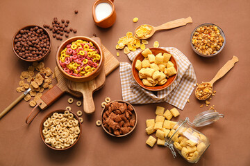 Composition with different cereals and milk on color background