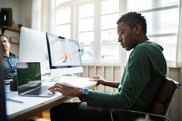 Casual African American businessman working in office