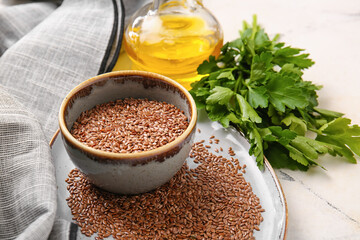 Composition with flax seeds, oil and parsley on light background, closeup