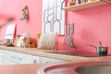 Utensils and plates on counter in kitchen