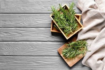 Composition with fresh rosemary on wooden background
