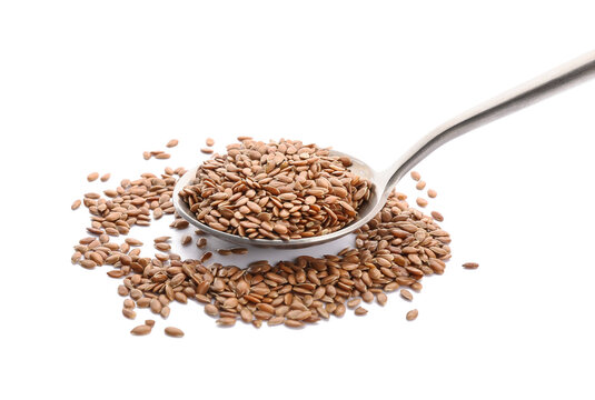 Spoon with flax seeds on white background