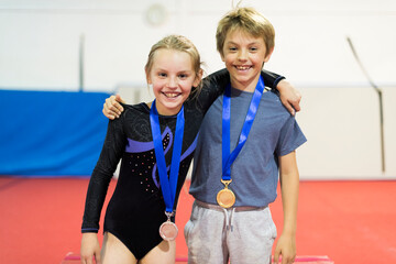 Young gymnasts with their medals - obrazy, fototapety, plakaty