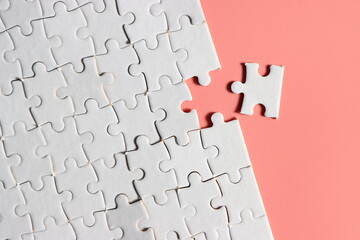 Jigsaw puzzle with missing piece. Missing puzzle pieces. Concept image of unfinished task. Completing final task, missing jigsaw puzzle pieces and business concept with a puzzle piece missing. pink